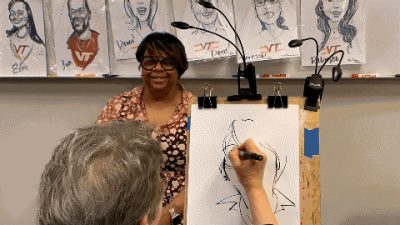 Torri Brown sits for the caricature artist