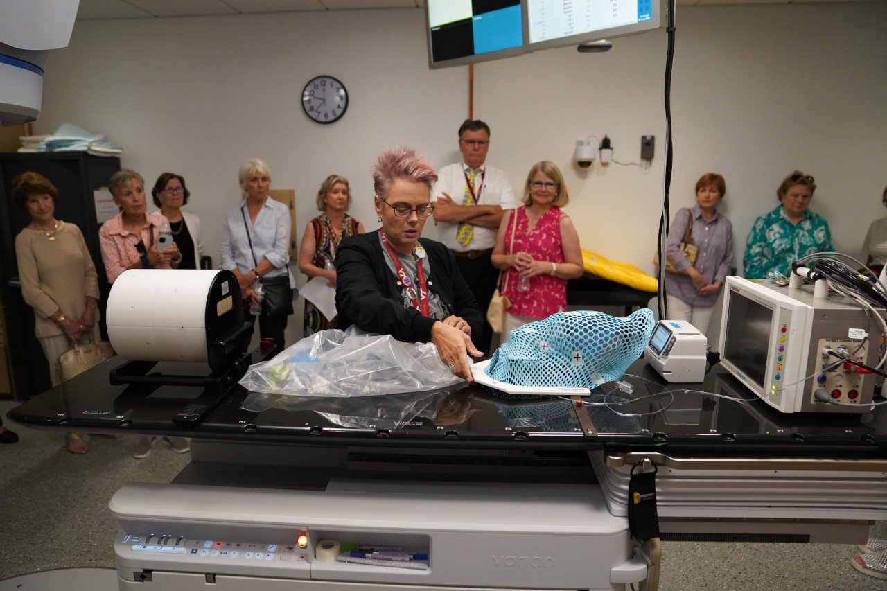 MeLora Bush, a radiation therapist, shows the group an example of a custom-made device that holds a pet's head still during radiation treatments in the Virginia-Maryland College of Veterinary Medicine's Animal Cancer Care and Research Center linear accelerator.