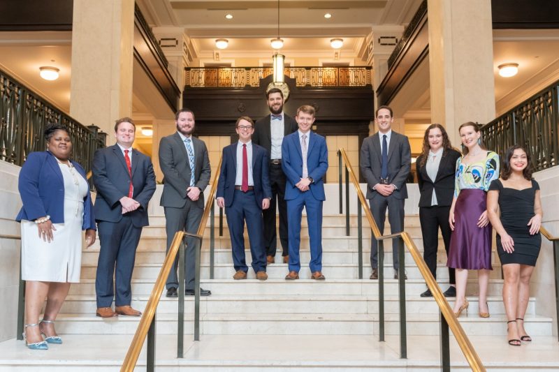 The 2021-2023 Virginia Management Fellows pose on a set of stairs for a group photo. 