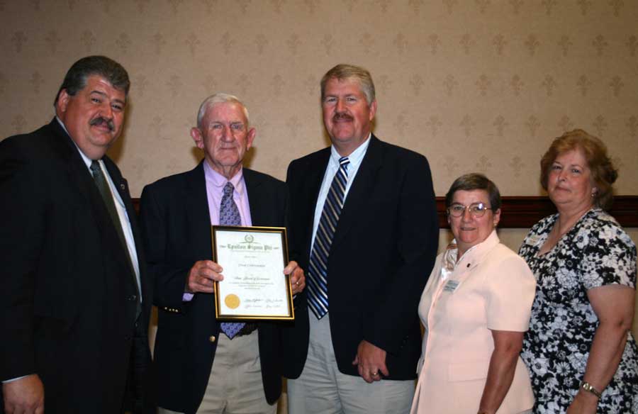 Crittenden (second from left) is presented with the 2008 State Friend of Extension award from Epsilon Sigma Phi. Celebrating the recognition are Mark McCann (far left), director of Virginia Cooperative Extension; David Moore (center), Extension agent, agriculture and natural resources; Cynthia Rowles (second from right), Extension agent, Virginia 4-H; and Paige Hogge (far right), unit administrative assistant.