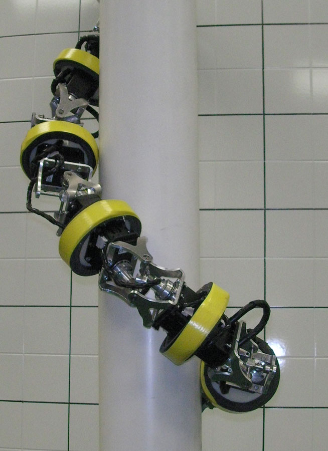 This HyDRAS serpentine robot prototype climbs a pole by converting the oscillating motion of the joints to a whole body rolling motion to climb up pole-like structures.