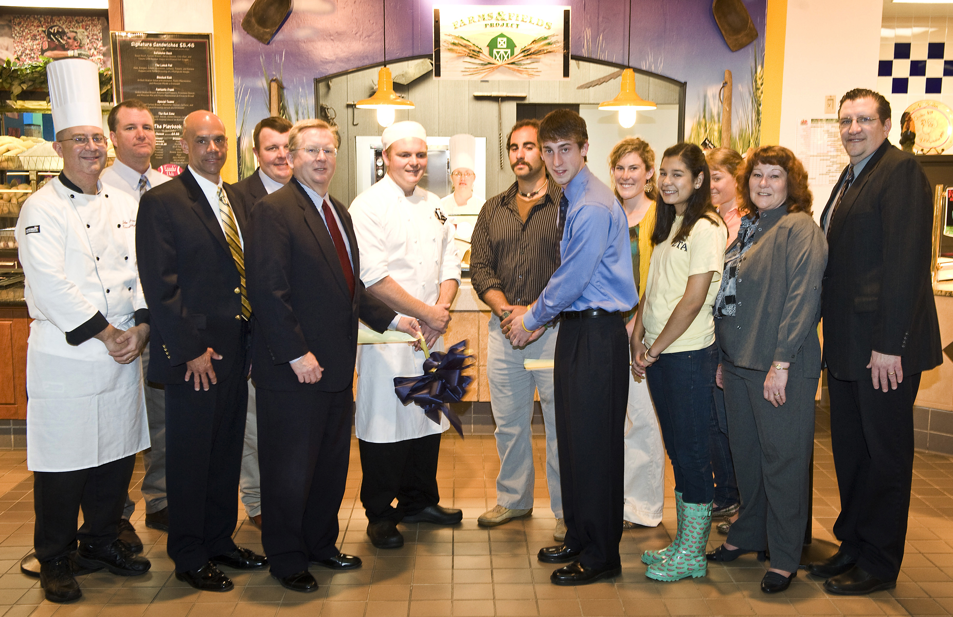 Students, administrators, and other contributors at the ribbon-cutting for the grand opening of the Farms and Fields Project in Owens Food Court in April 2009.