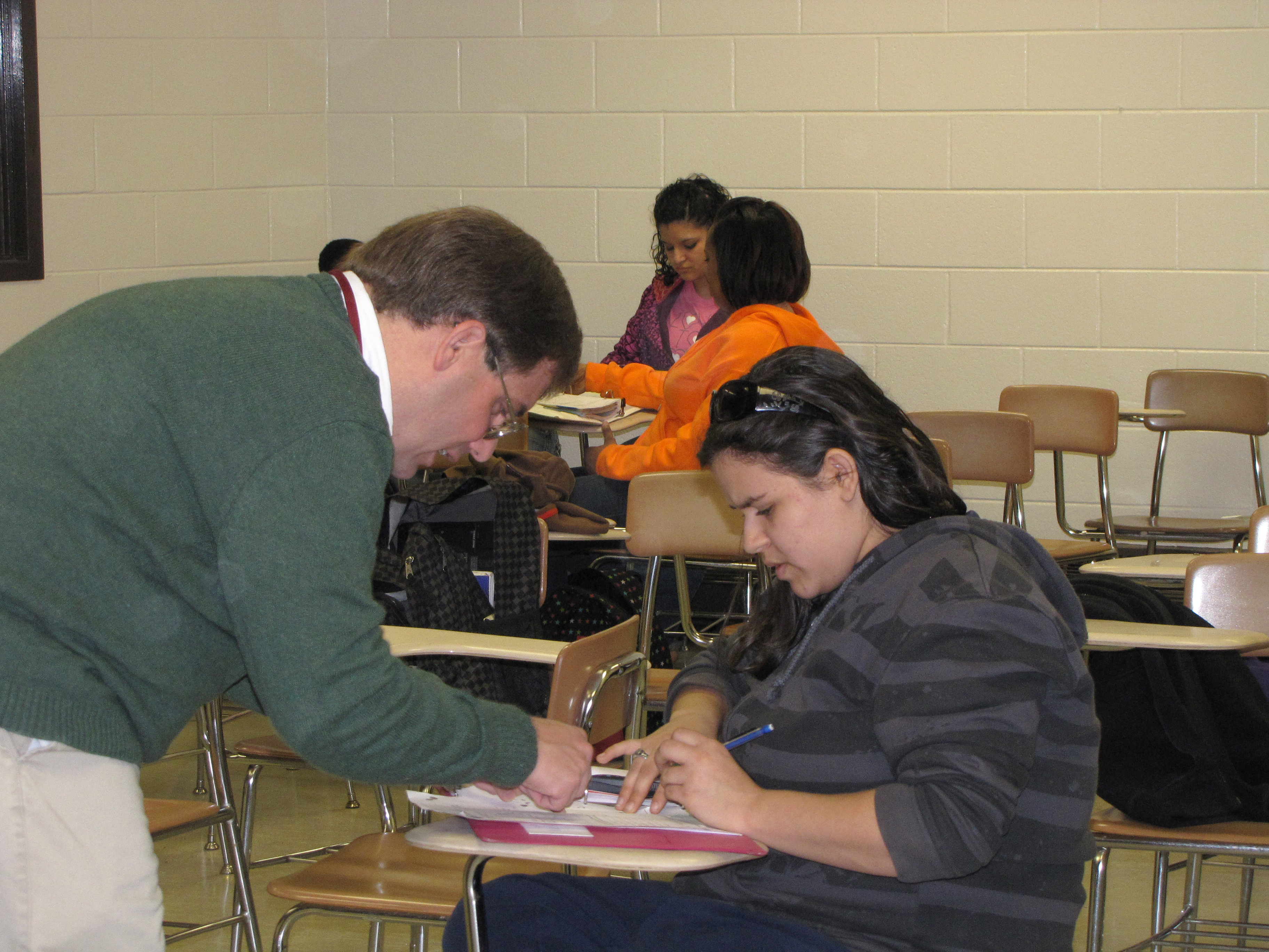 A tutor counsels a student at an Upward Bound session.