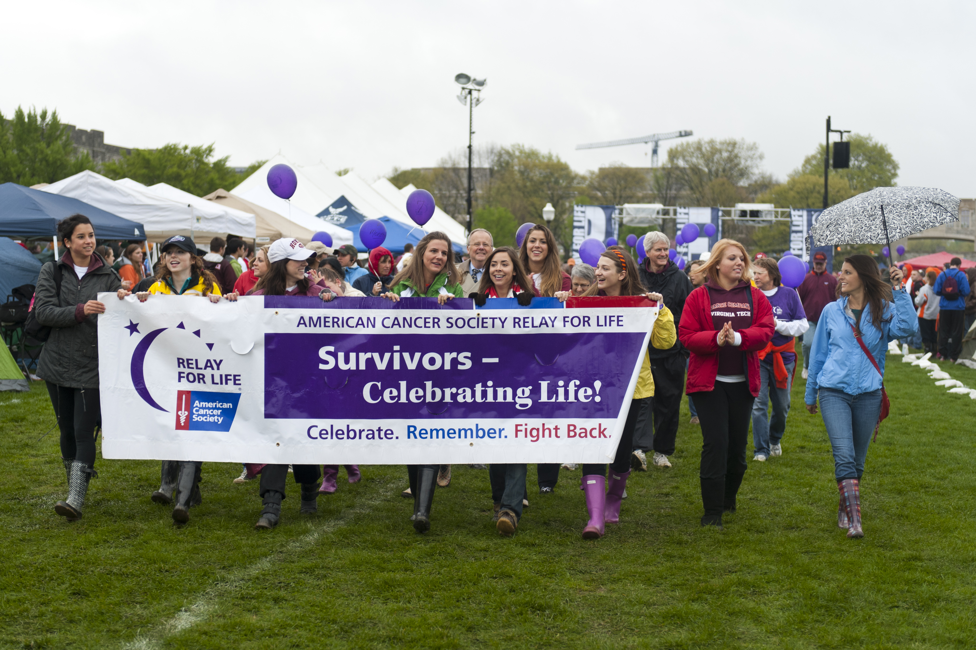 Group carries the cancer survivors' banner around the Relay For Life track