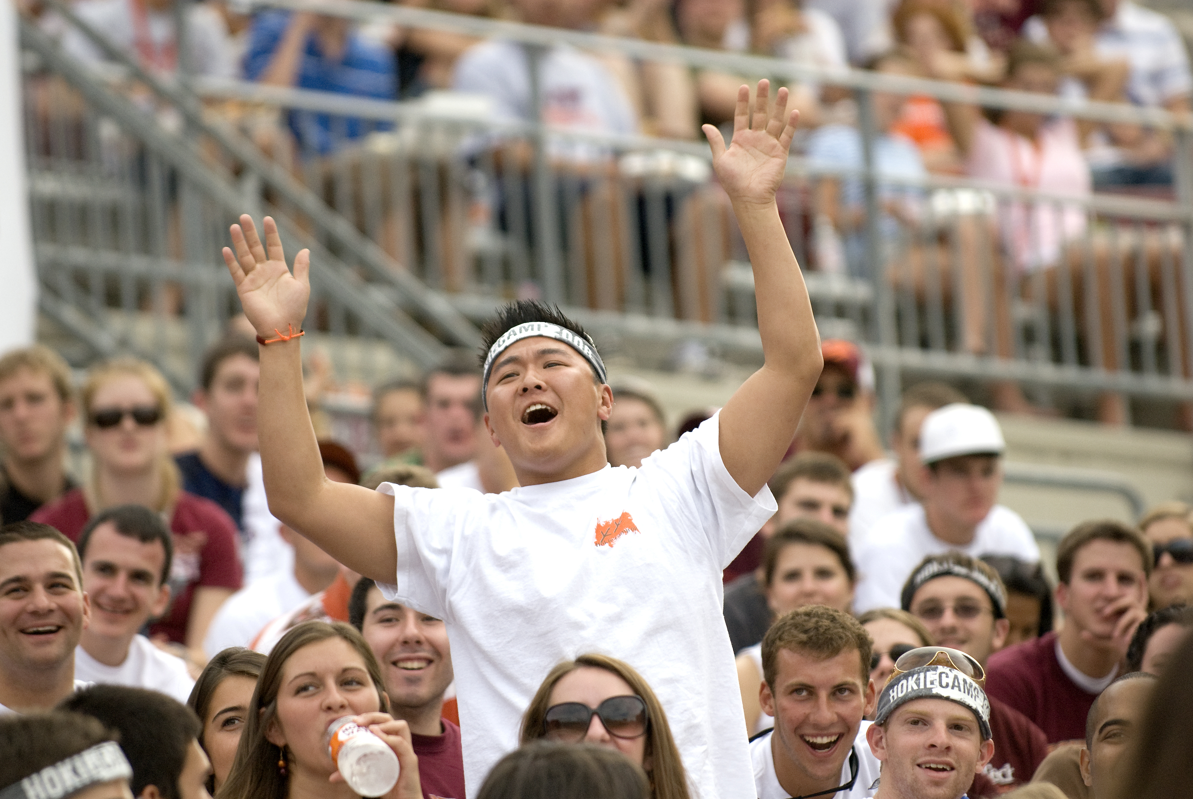 Students cheer in the stands at the Welcome Picnic