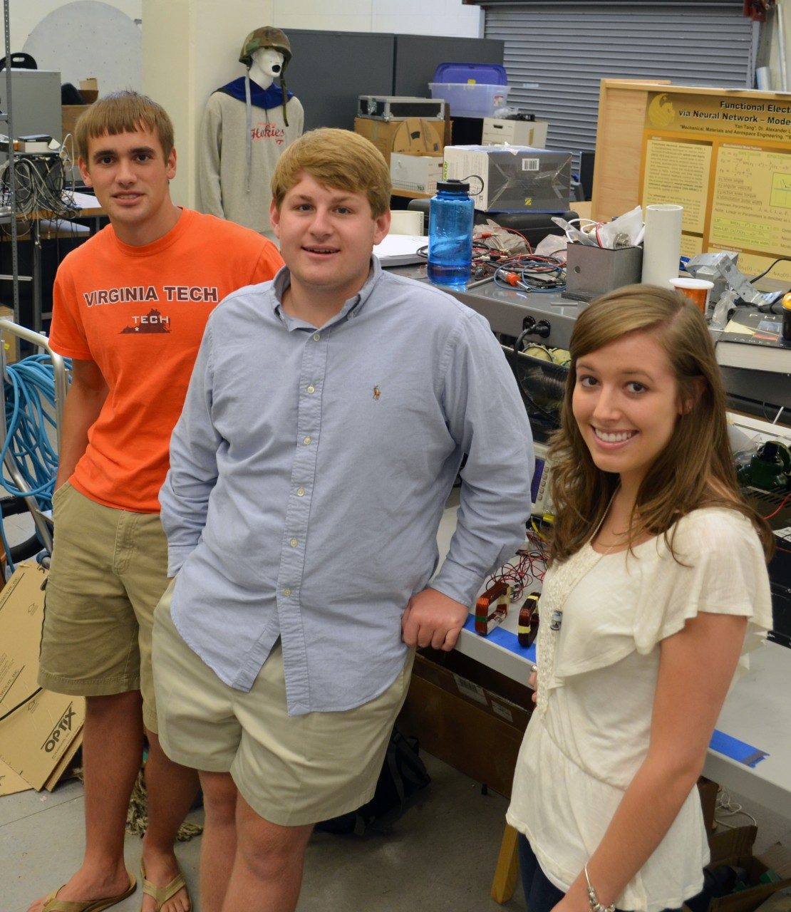 Scieneering students Garret Burks, Kyle Harring, and Madison Preib (left to right) stand in their summer research laboratory space in Durham Hall.