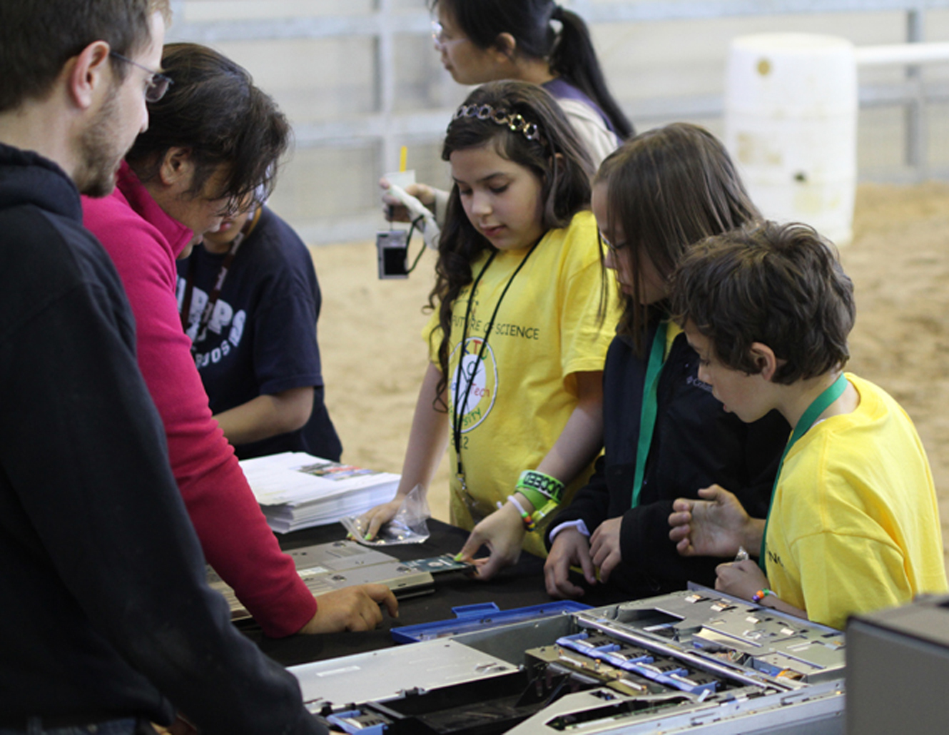 Children engaging with science at the Rackspace booth during Kids' Tech University hands-on activity.