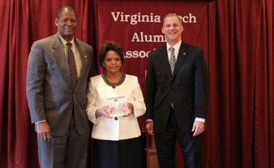 Alan Grant (right), dean of the College of Agriculture and Life Sciences, presents Winston and Marilyn Samuels with an award as they are inducted in the college's Hall of Fame.