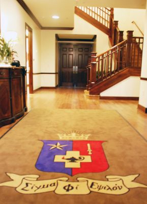 Carpet with crest in the fraternity house entrance.