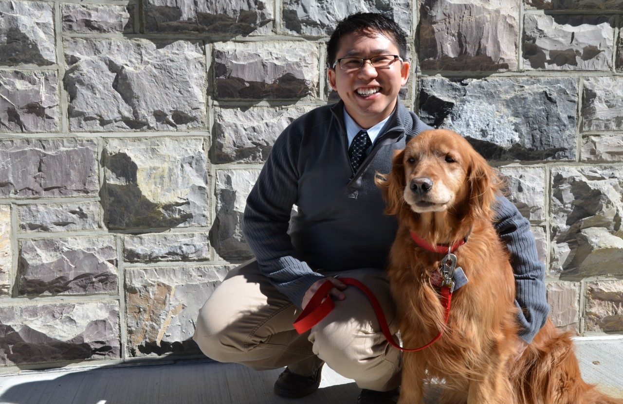 Dr. Zenithson "Zenny" Ng with his certified therapy dog, Grace.