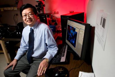 Dr. X.J. Meng with microscope