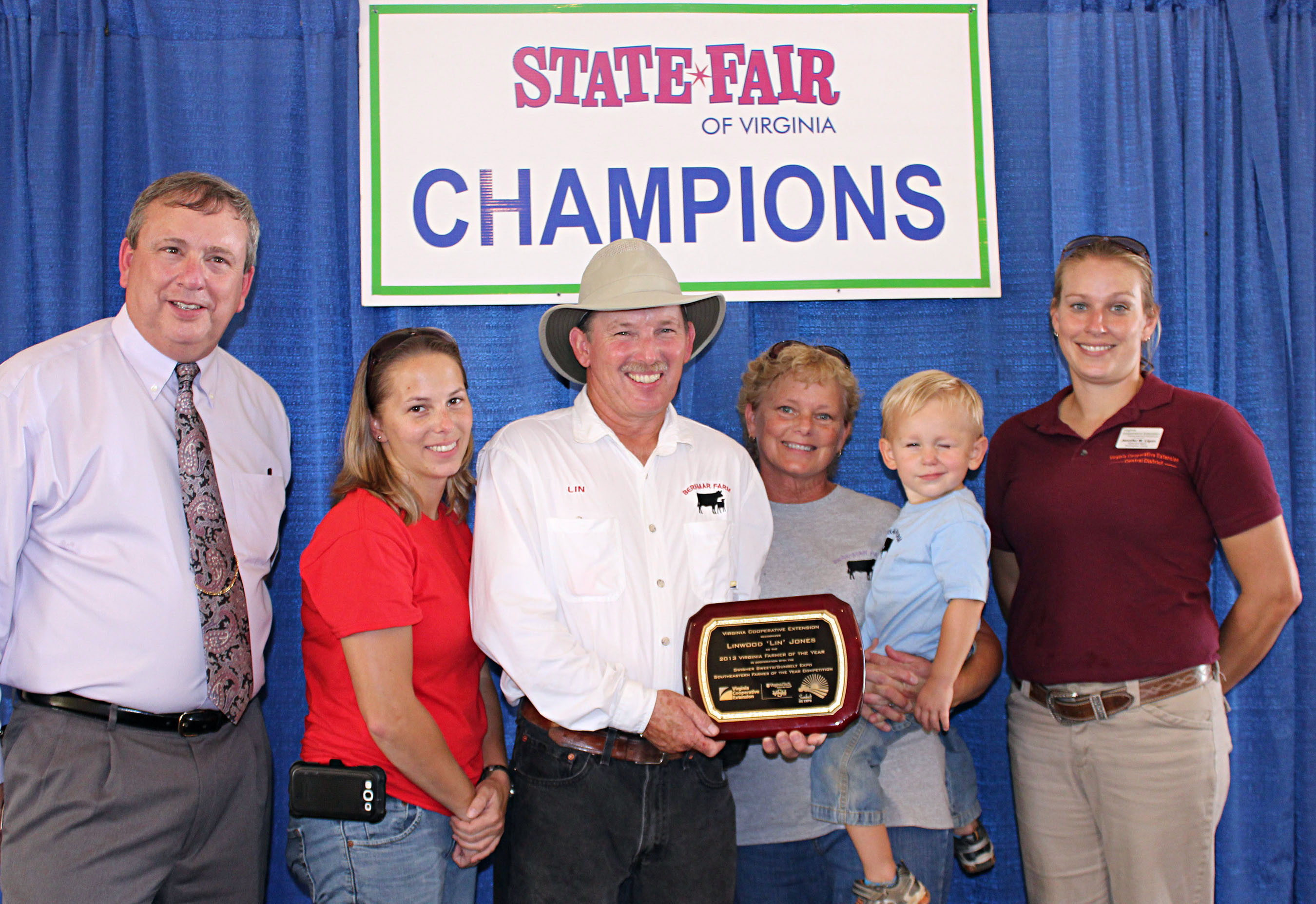 Farmer of the Year plaque presentation. Berkley Linwood "Lin" Jones with family and Extension faculty.