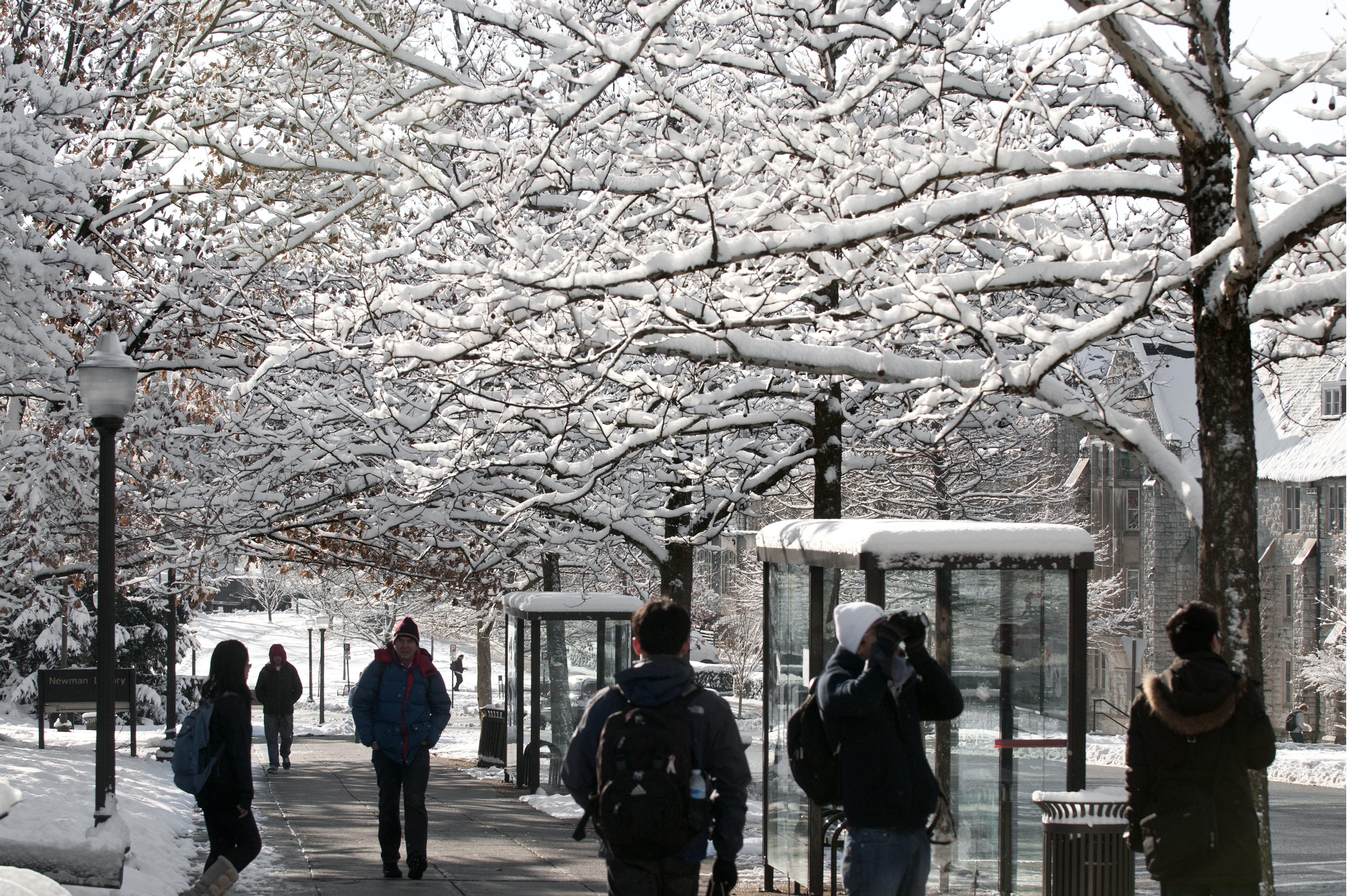 Students walk on a snow-covered campus