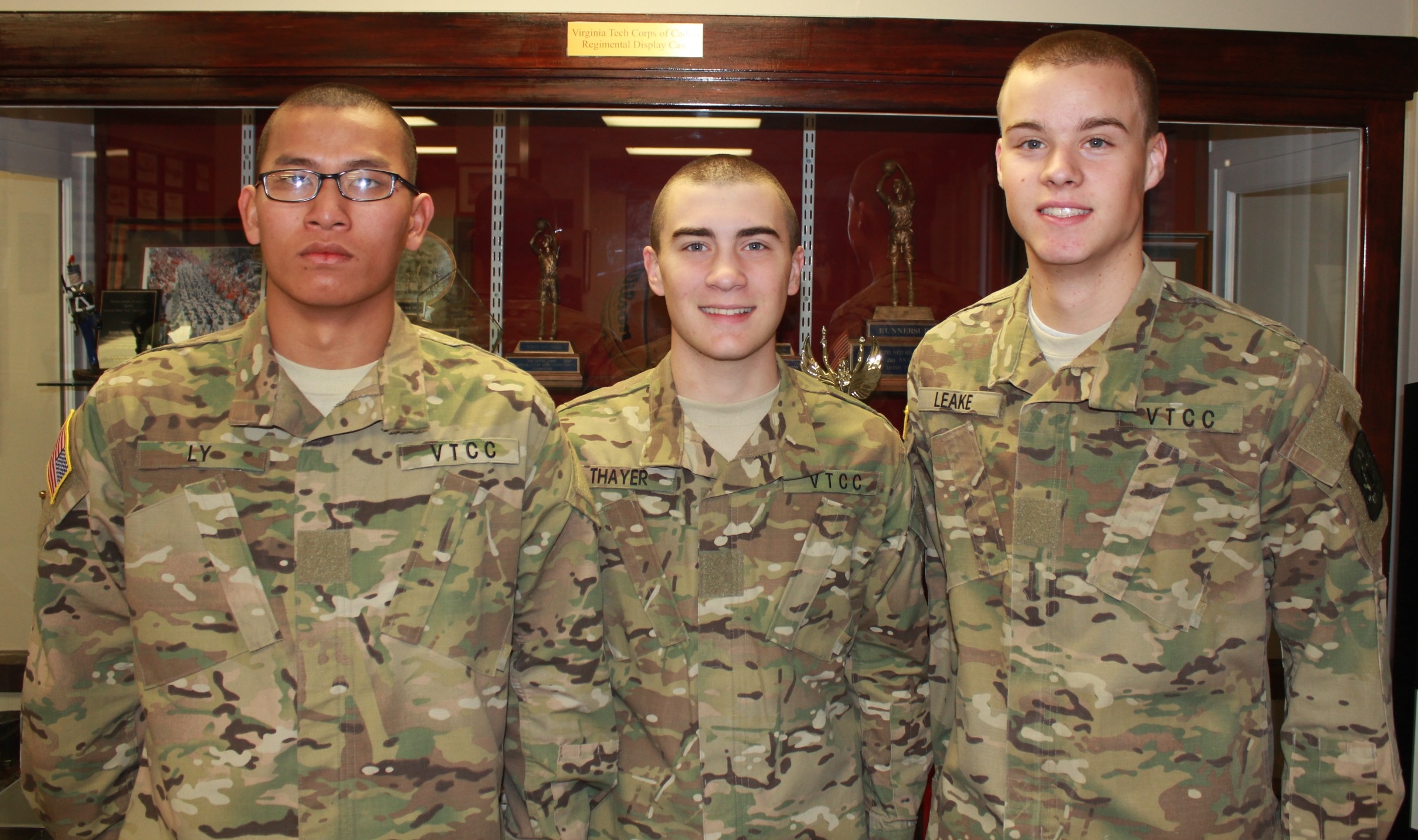 Cadets Tau Be Ly, Michael Thayer, and Austin Leake in Brodie Hall.