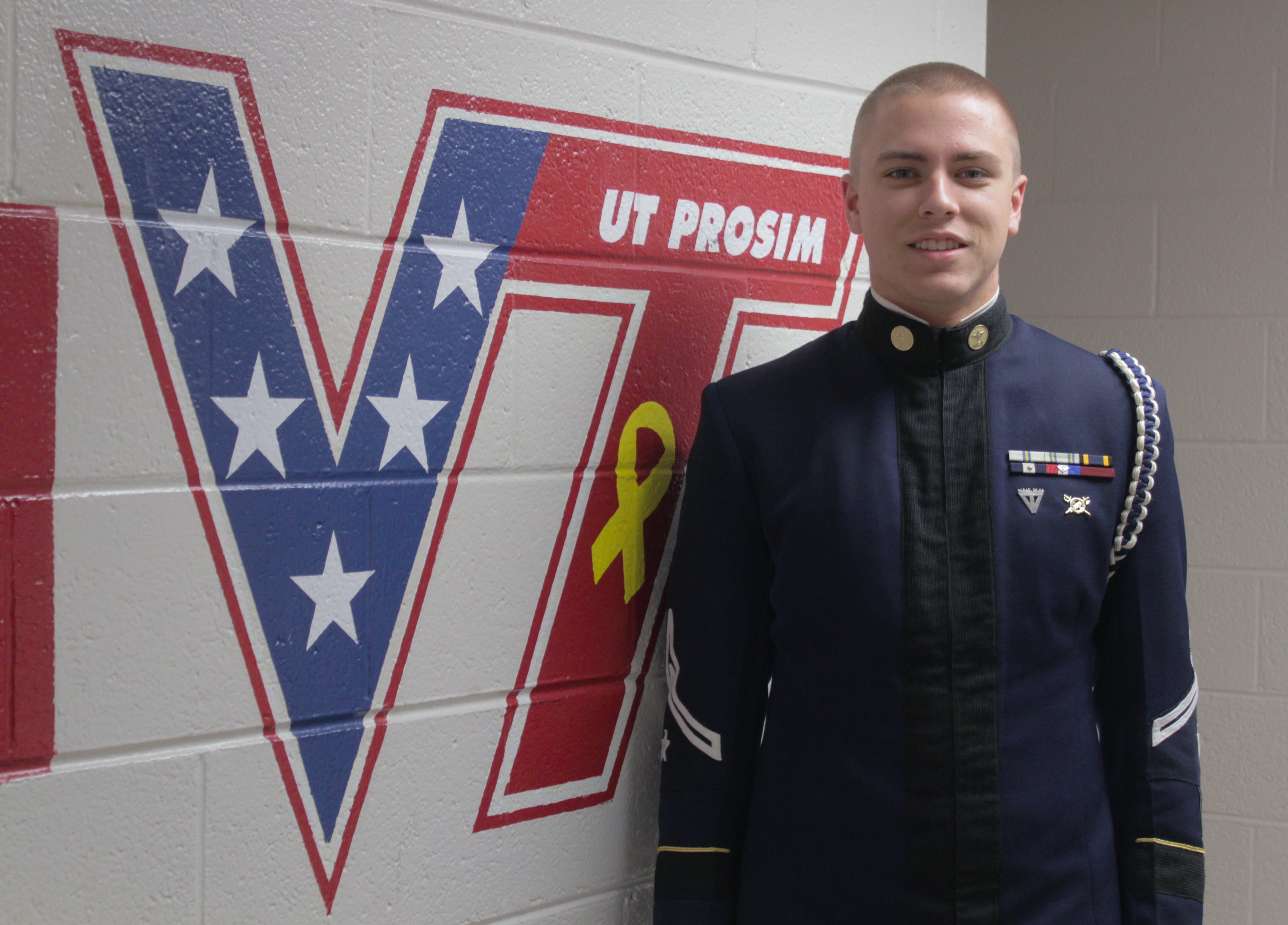 Cadet Christopher Blaney stands in a cadet hallway.