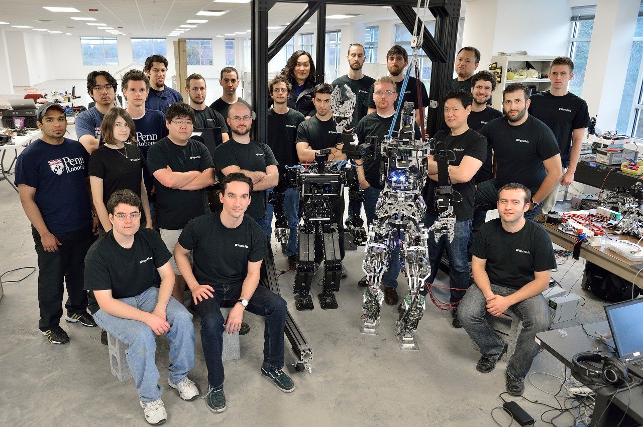 Team THOR, consisting of the Robotics and Mechanisms Laboratory of Virginia Tech and the GRASP robotics team from University of Pennsylvania, pose with the robots, THOR and TJOR-OP. THOR is short for Tactical Hazardous Operations Robot.