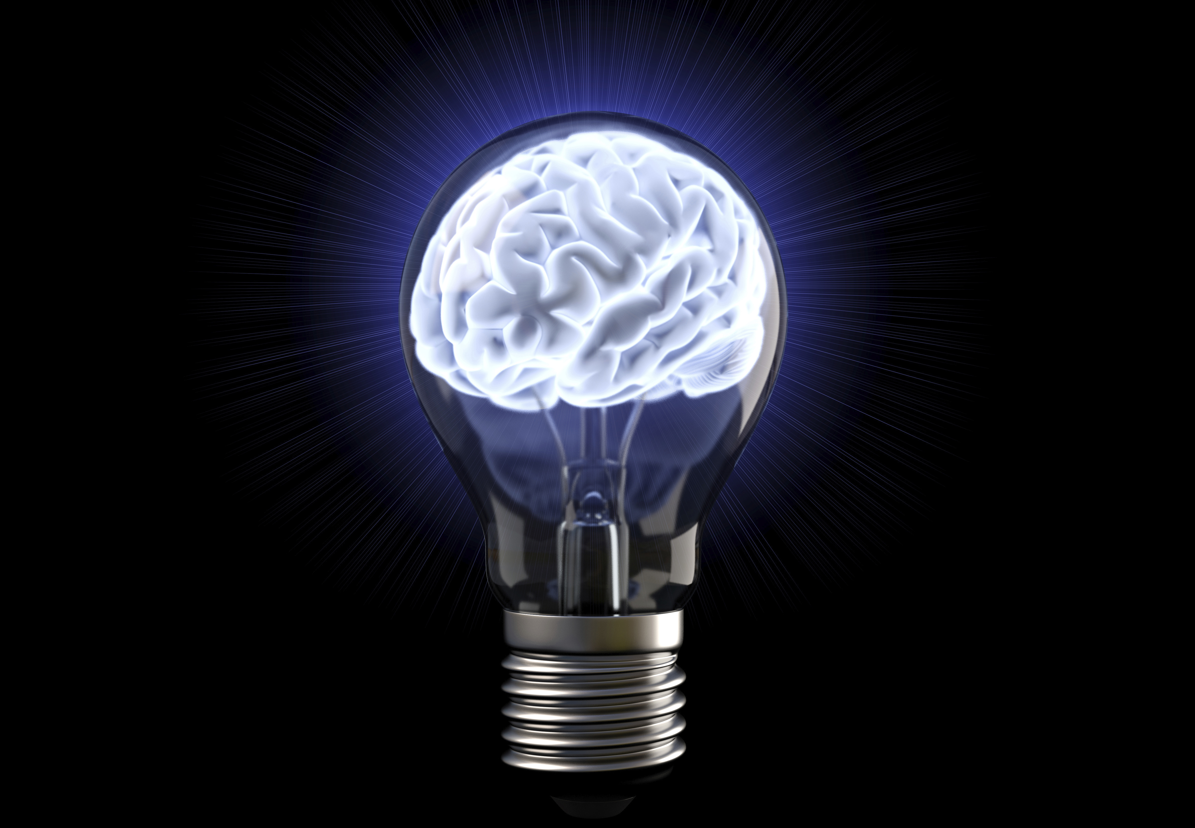 A lightbulb encases a glowing brain