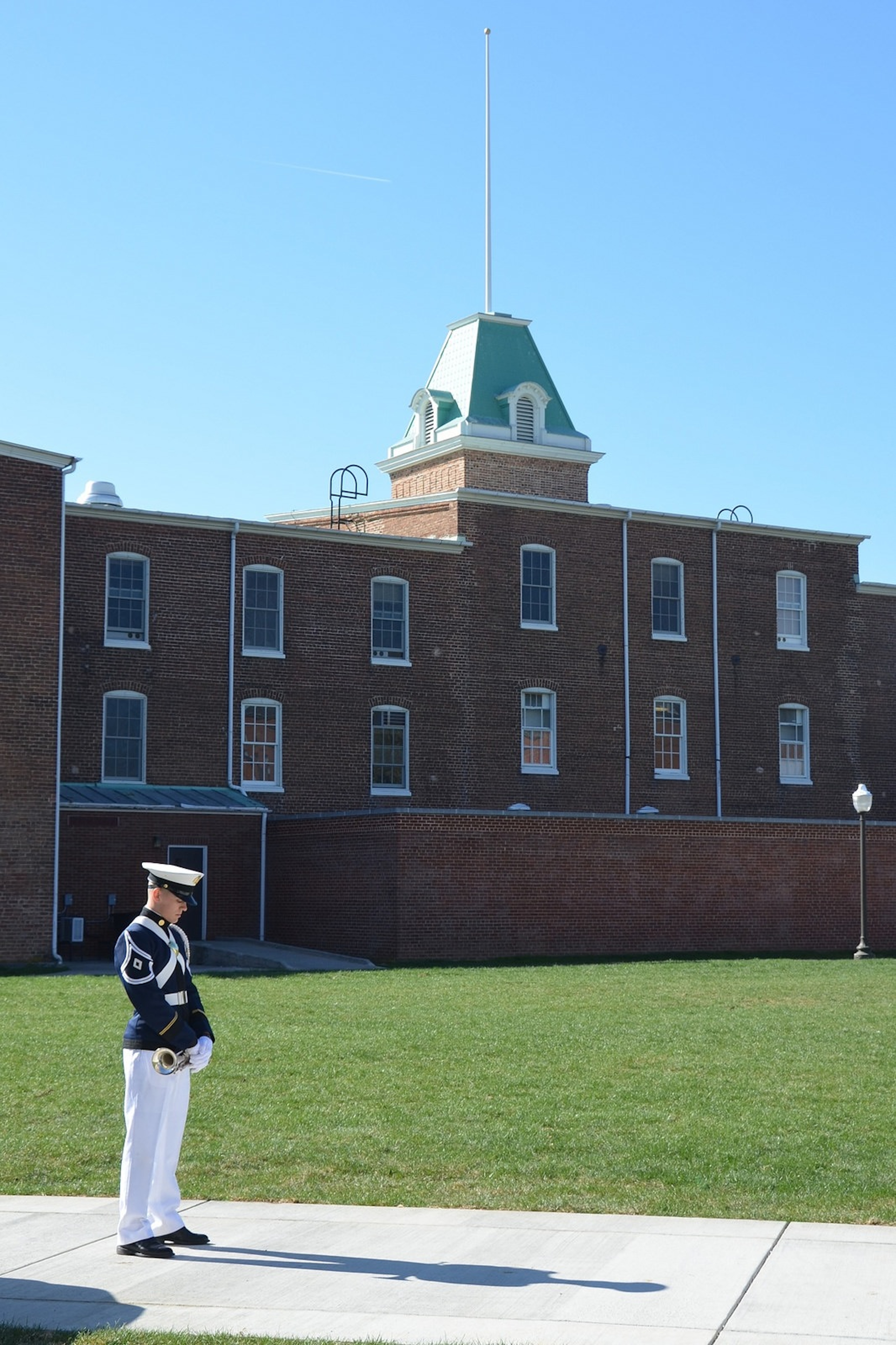 A bugler from the Virginia Tech Corps of Cadets stands ready behind Lane Hall to perform Echo Taps