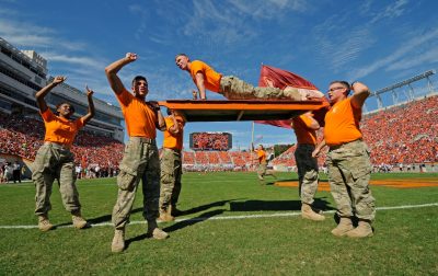 Esprit member does push ups on a board lifted in the air by other team members after a Hokie touchdown during the homecoming game this year.