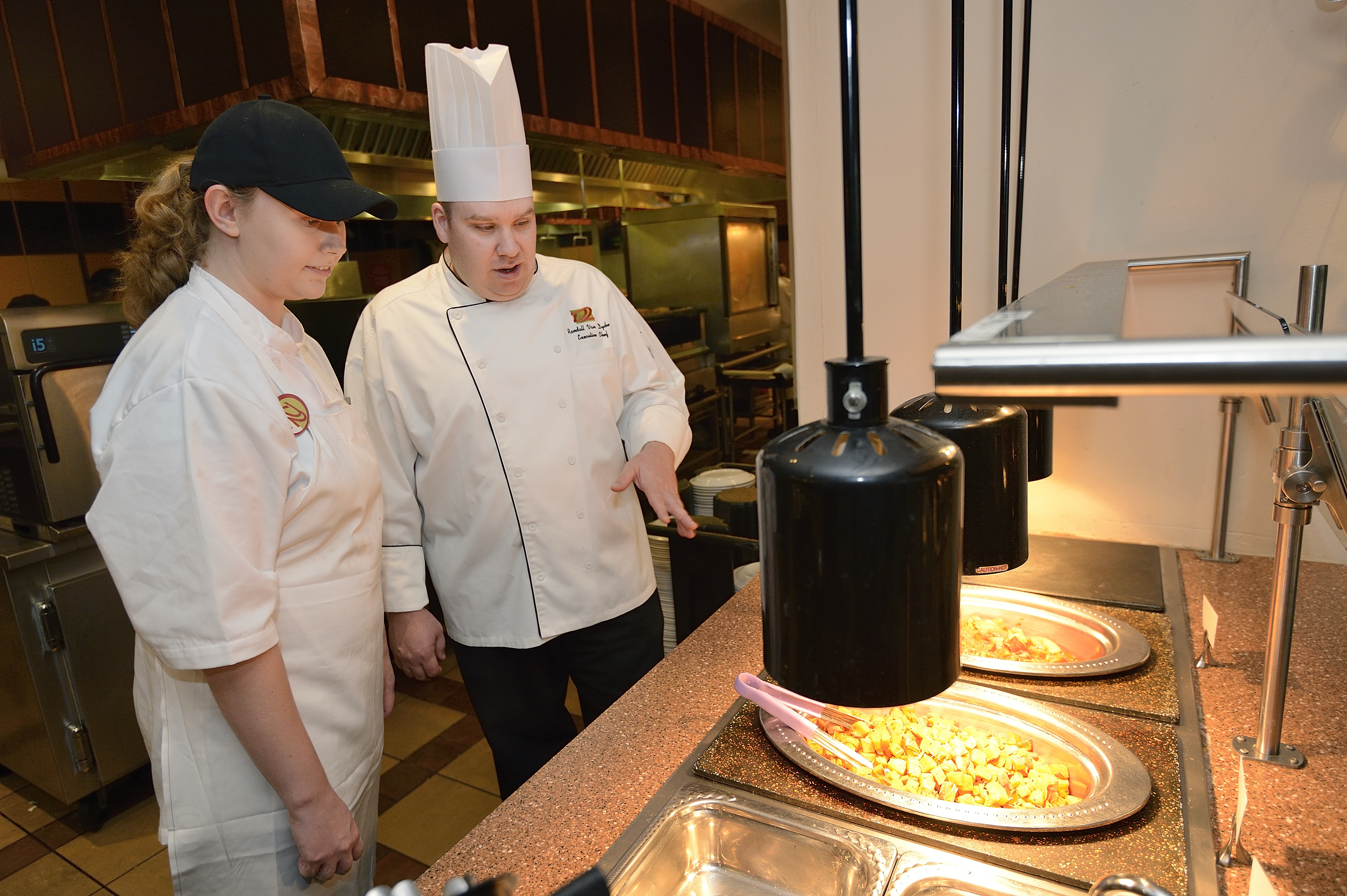 Chef Randall Van Dyke, executive chef of D2, stands with another employee as they prepare to serve dinner.