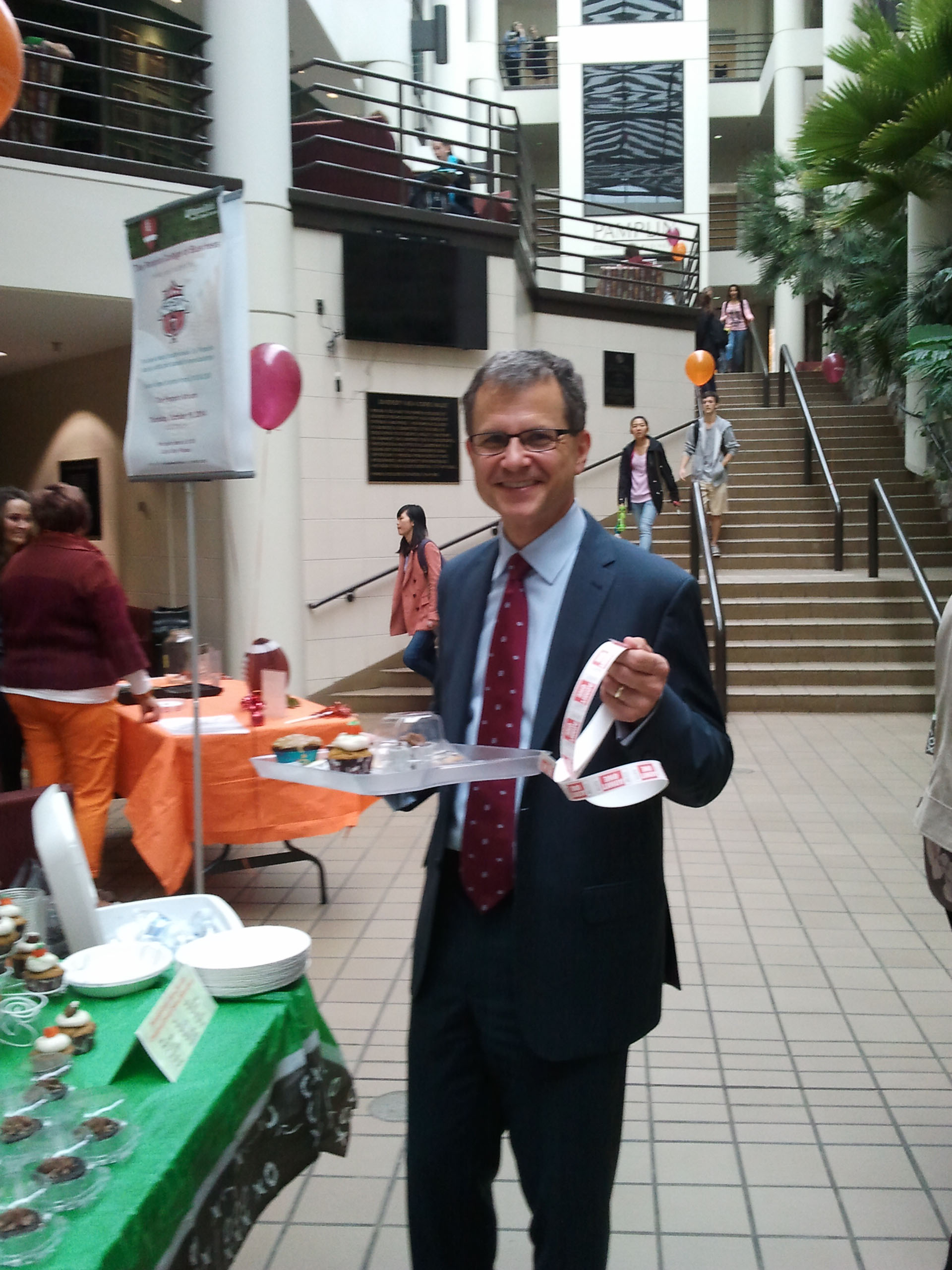 Pamplin dean Robert Sumichrast holds the tray of baked goods that he bought at one of the fundraisers the college's faculty and staff organized to support the CVC.