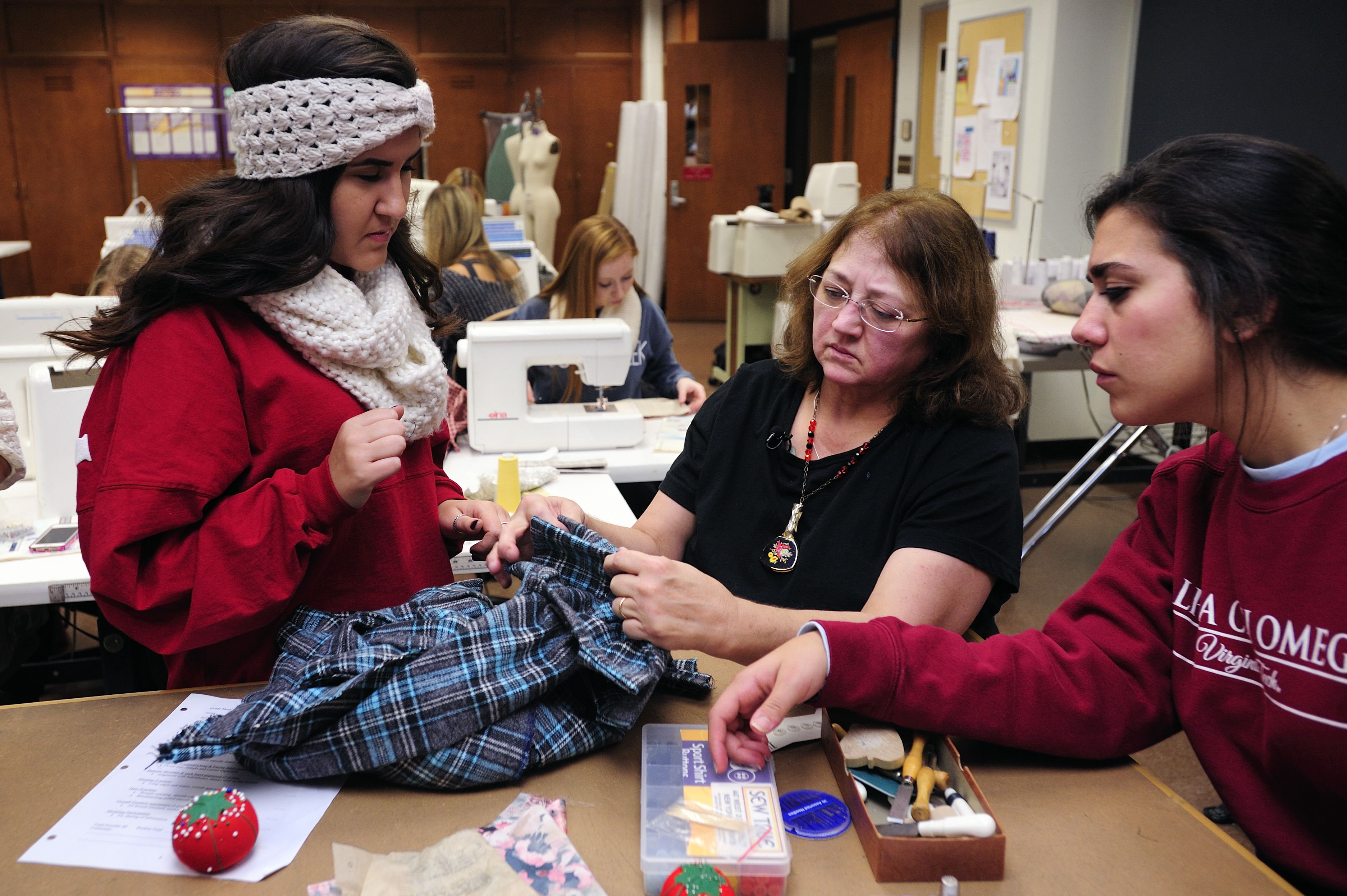 Peggy Quesenberry works with students in an apparel production class.