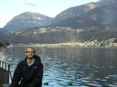 Seth Lowe sitting by Lake Lugano in Riva San Vitale, Switzerland.