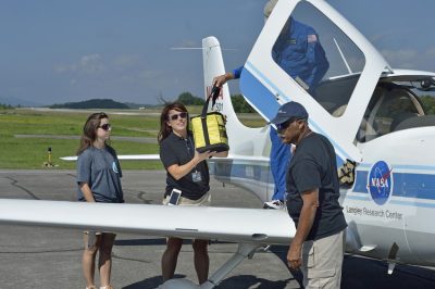 Personnel from Health Wagon and the Appalachian College of Pharmacy receive medical supplies delivered by a NASA SR-22 aircraft.