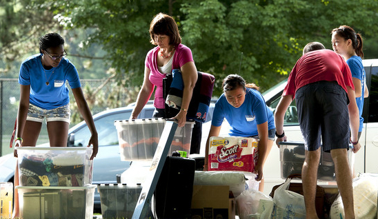Students unloading boxes from cars during move-in