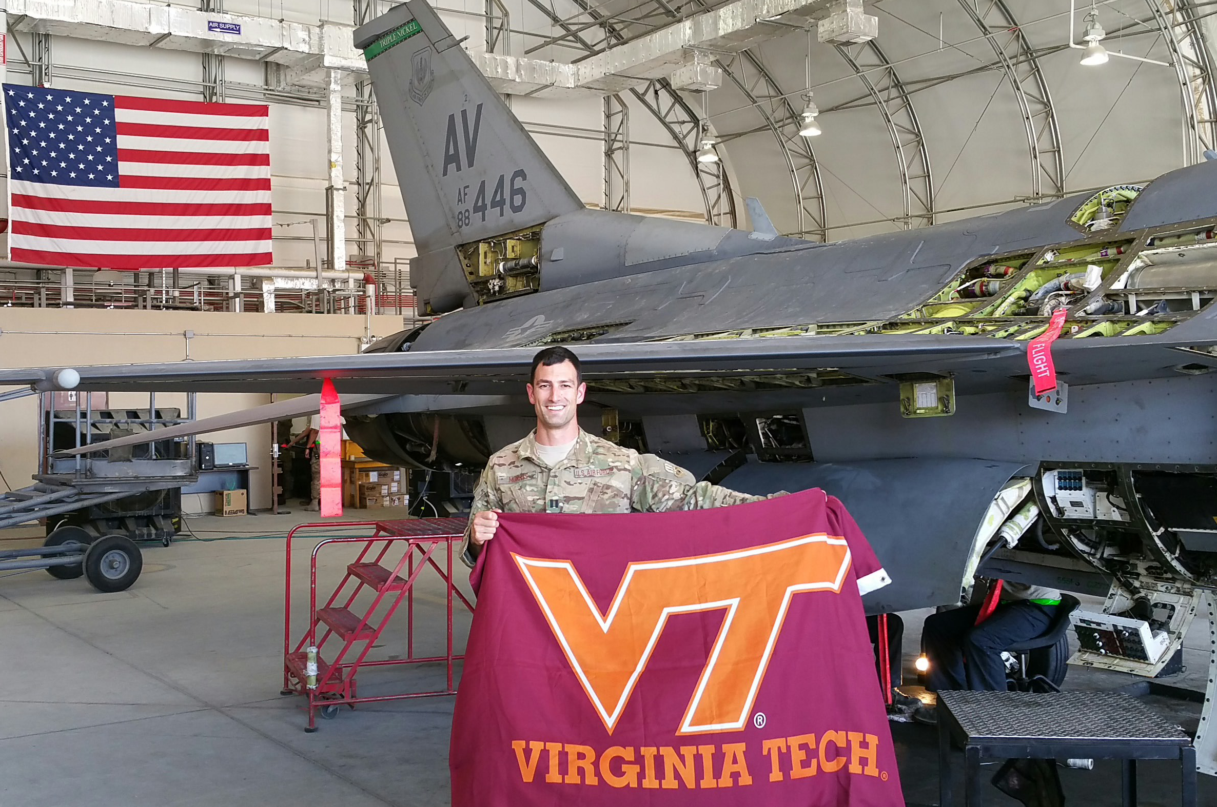 Capt. Ryan Morris, U.S. Air Force, Virginia Tech Corps of Cadets Class of 2009 in front of an F-16.