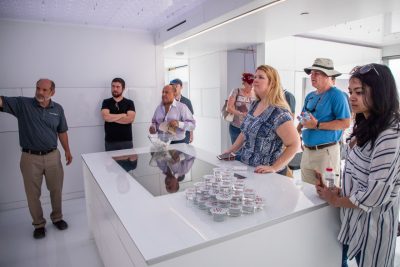 Joe Wheeler (left) leads a tour of FutureHAUS for VIrginia Tech alumni at the site of the Solar Decathlon Middle East.