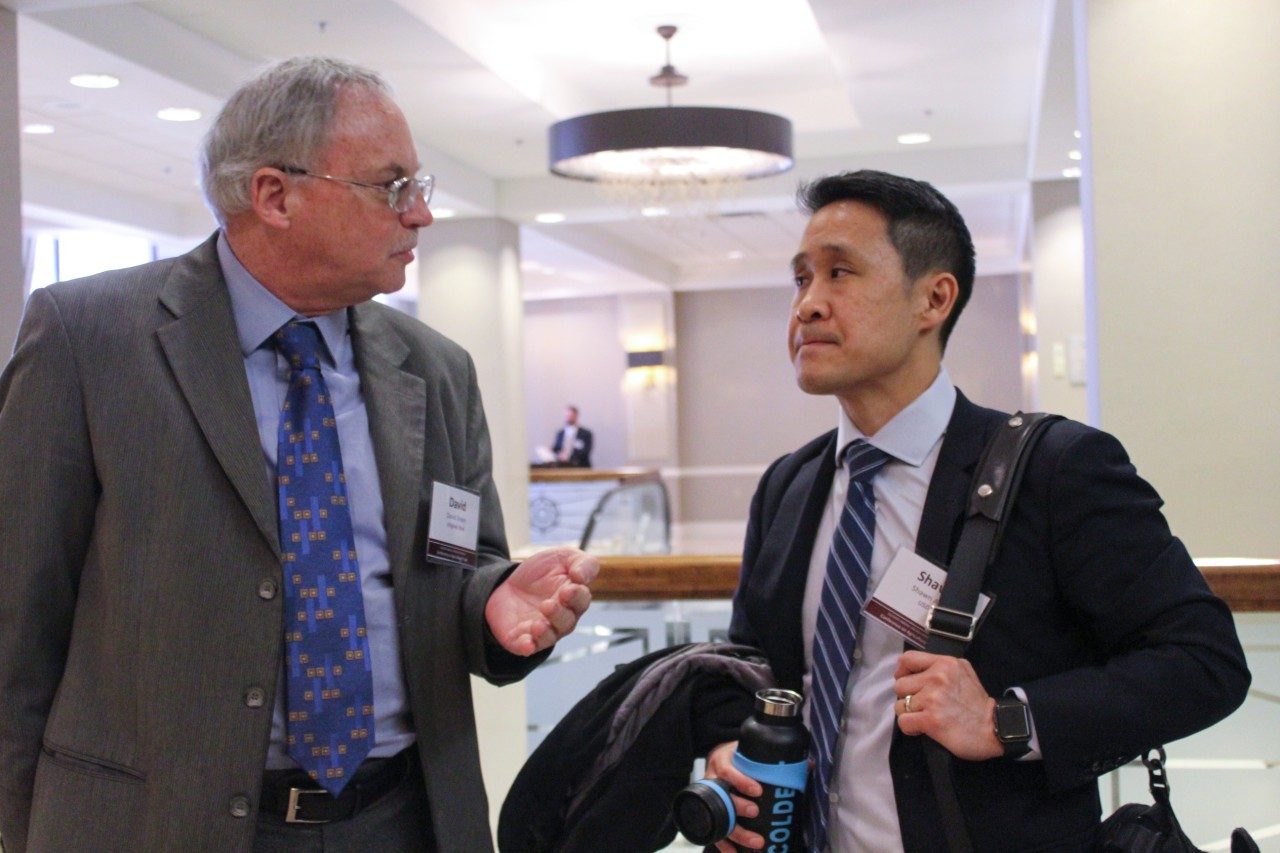 Professor David Orden speaks to Shawn Arita of the United States Department of Agriculture. 