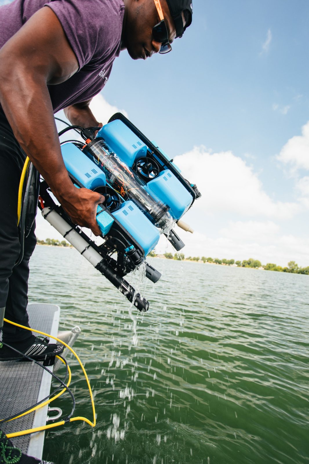 Undergraduate student Bryan Bloomfield from Morehouse College is seen recovering a heavy, light blue ROV from Grand Lake St Marys, Ohio. The lake is extremely green. Courtesy of Christina+David. 