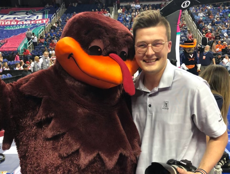 Liam Sment huddles with the Hokie Bird during an ACC Women’s basketball game in March 2020, just prior to the placement of COVID-19 pandemic restrictions. Photo courtesy of Liam Sment.