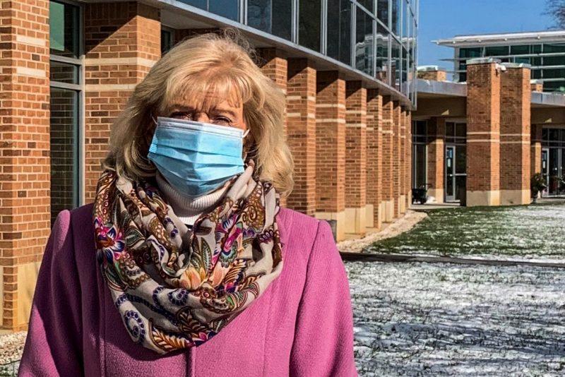 Director Penny McCallum stands masked in front of the Southwest Center.