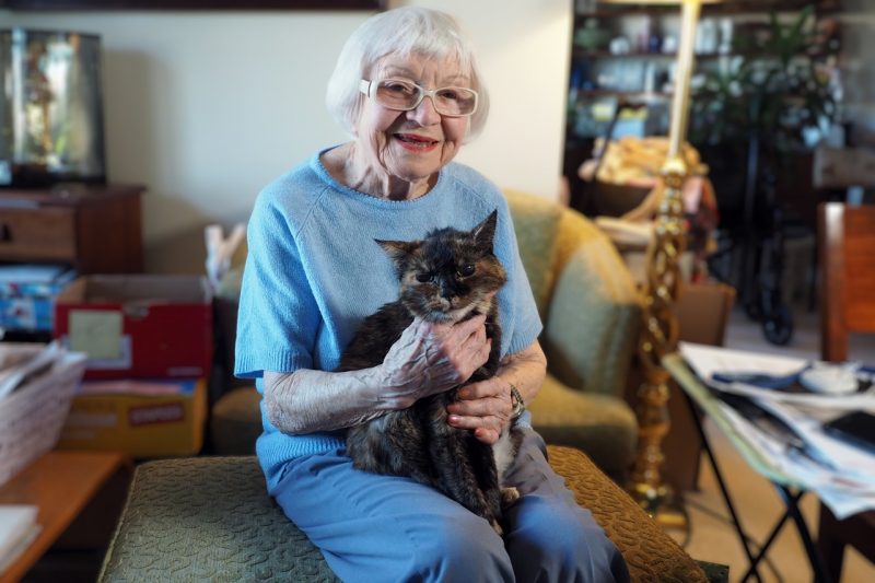 Evelyn Blake enjoys a moment in her home with her feline companion, Callie. 
