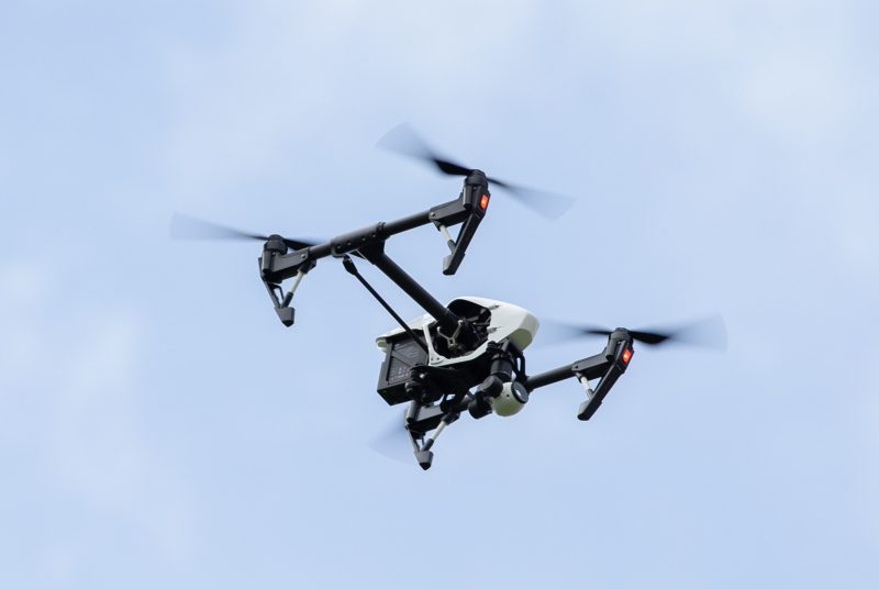 A drone in flight against a blue sky background