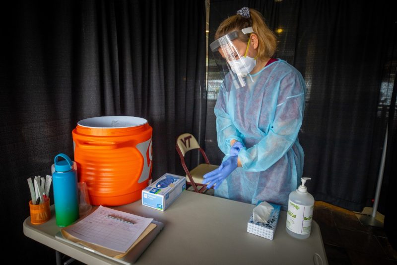 Emily Schofield prepares for one of many COVID-19 swab tests at Lane Stadium. Photo by  Ray Meese.
