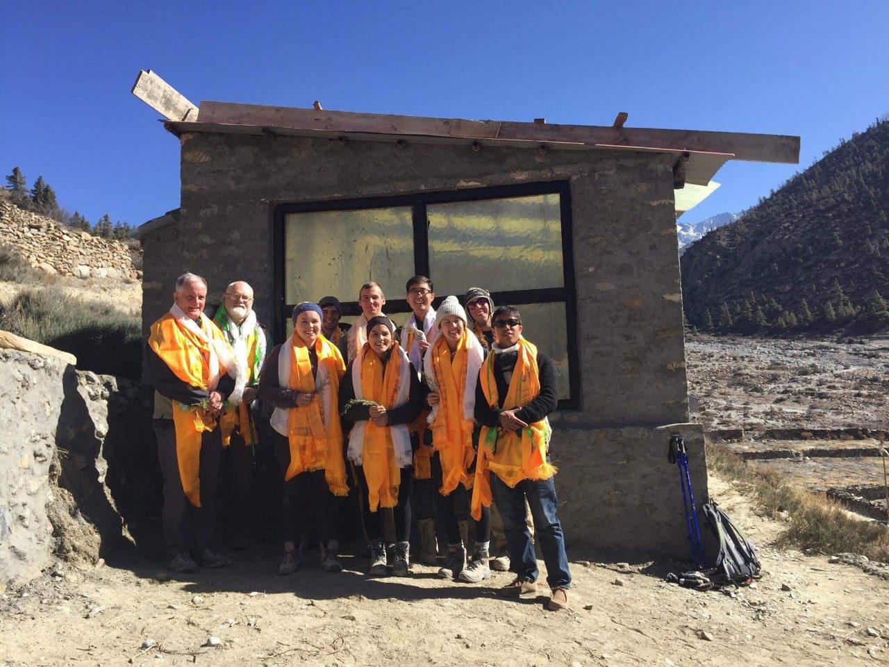 Virginia Tech's Service Without Borders team in front of a warming hut during the Winter 2017-18 trip to Nepal. Back row, from left: Tom Hammet, Professor of Sustainable Biomaterials; Brian Benham, Professor Biological Systems Engineering; Alfonso Marino; Mark Shepheard; Julian Park; Evan Charnoff. Front Row, from left: Sylvia Connor;  Sara Herndandez; Lauren Holt; and Tsewang Gyurme, in country contact/local guide. Photo submitted by Mark Shepheard.