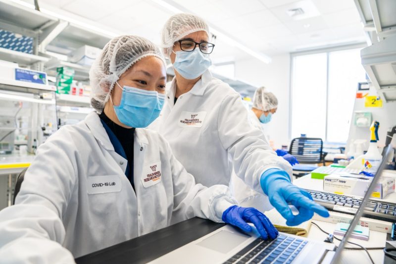 Carla Finkielstein (right), an associate professor at the Fralin Biomedical Research Institute at VTC, performs analysis on COVID-19 samples. The institute of one of Virginia Tech's thematic research institutes.