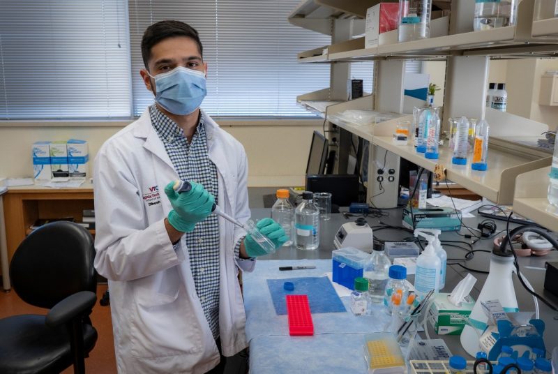 Medical student conducting experiment in research lab.