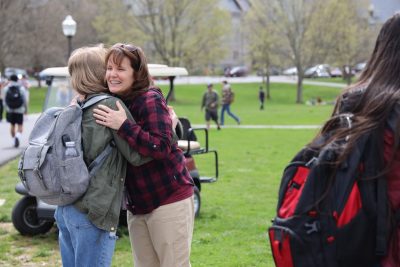 Mom Carla McCabe hugs a student on Virginia Tech campus.