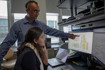 Computer science researcher T.M. Murali and graduate student Nure Tasnina look over data.