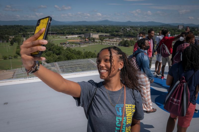 A high school student from the Achievable Dream Academy takes a selfie atop the Carilion Clinic Roanoke Memorial Hospital helipad.