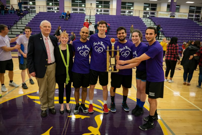 Students from the Virginia Tech Carilion School of Medicine hold the trophy alongside the Harringtons at the 2020 Docs for Morgan event. 