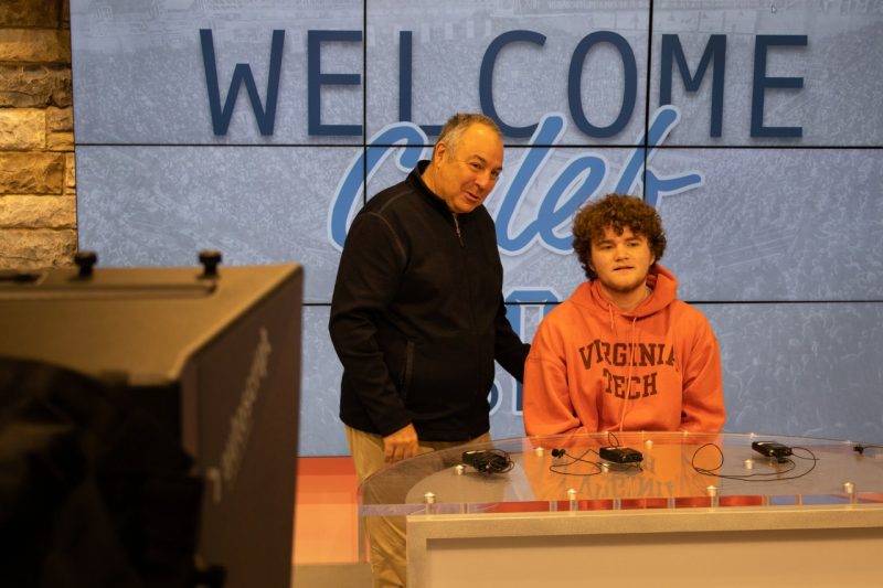 Bill Roth (at left) and Caleb Henegar (at right) prepare to report on Virginia Tech's men's basketball team inside the Moss Arts Center multimedia center. Photo by Cory Van Dyke for Virginia Tech.