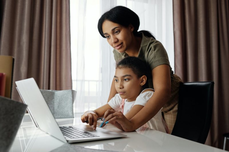 Parent and child look at a computer screen