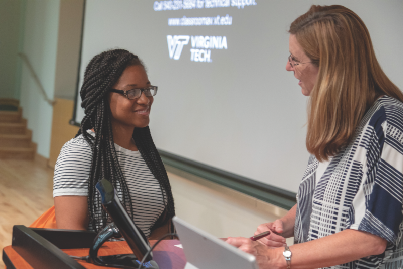 A high school student talks with Dean Julie Ross (right) following a presentation for the Black College Institute Pre-College Program in 2018.