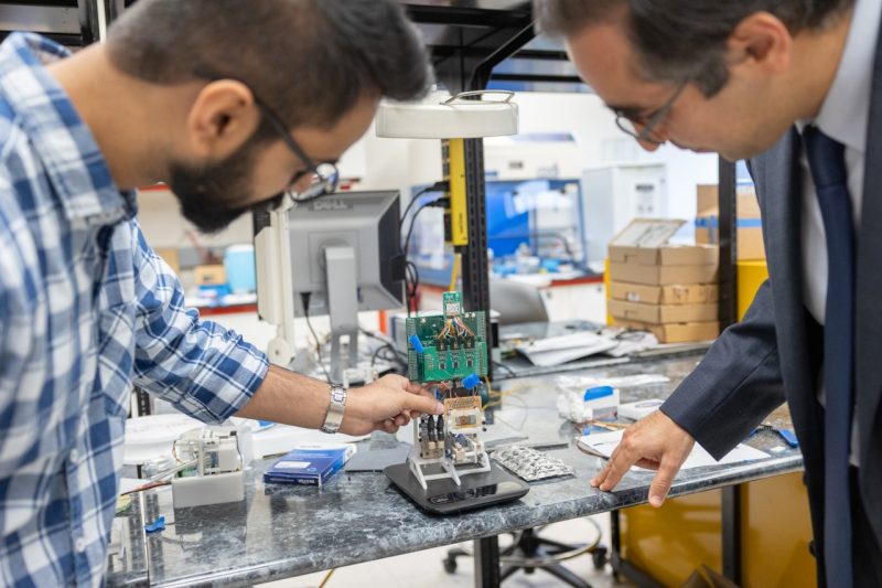 Masoud Agah (at right) and graduate student Nipun Thamatam discuss improvements for the next version of the SenSorp prototype. Photo by Chelsea Seeber for Virginia Tech