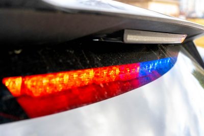 The new Virginia State Police patrol vehicle lighting pattern utilizes both red and blue lights. The rear of a patrol car with red and blue lights in the rear view window.